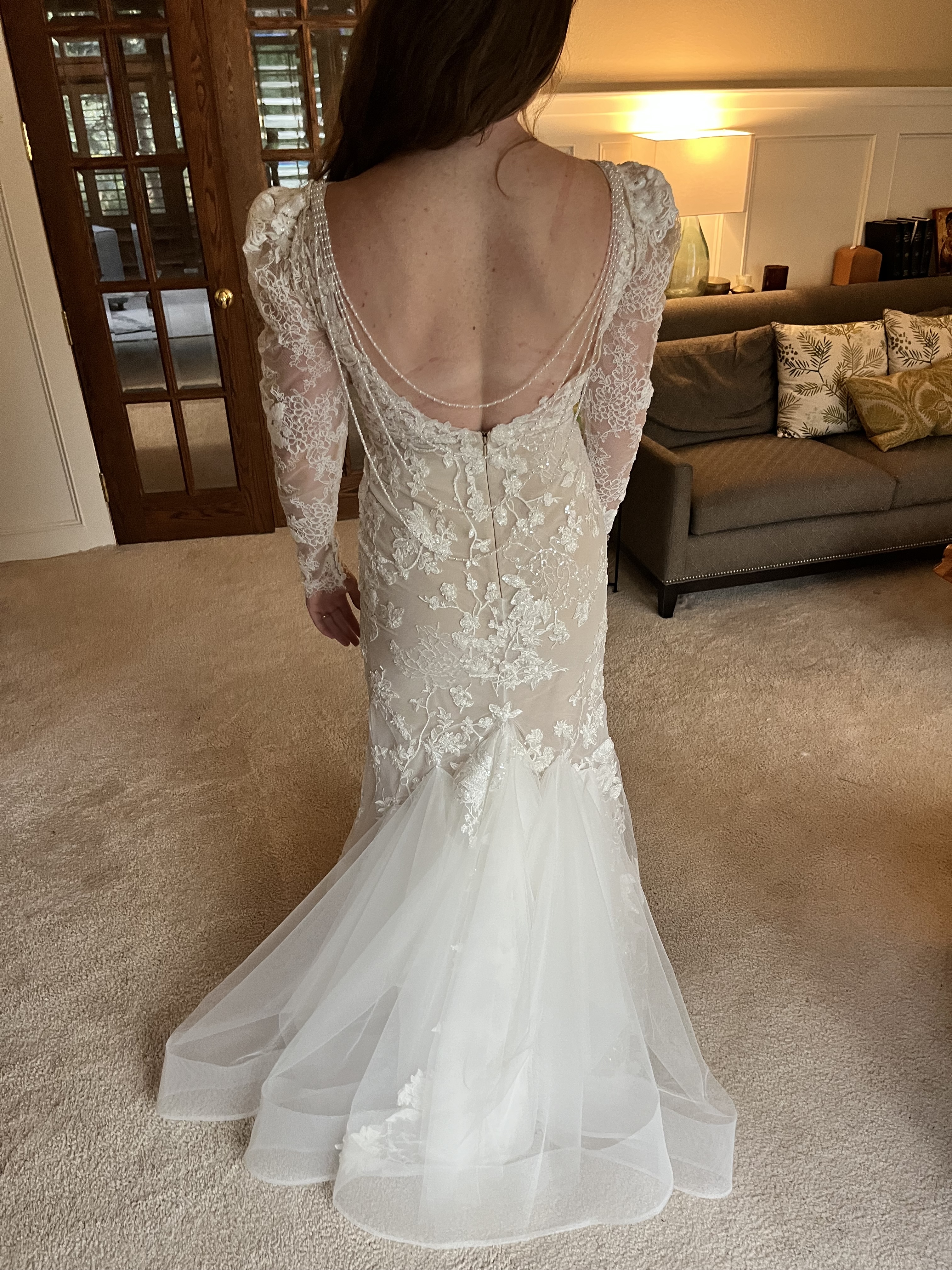 Bridal gown with bustle and removable sleeves