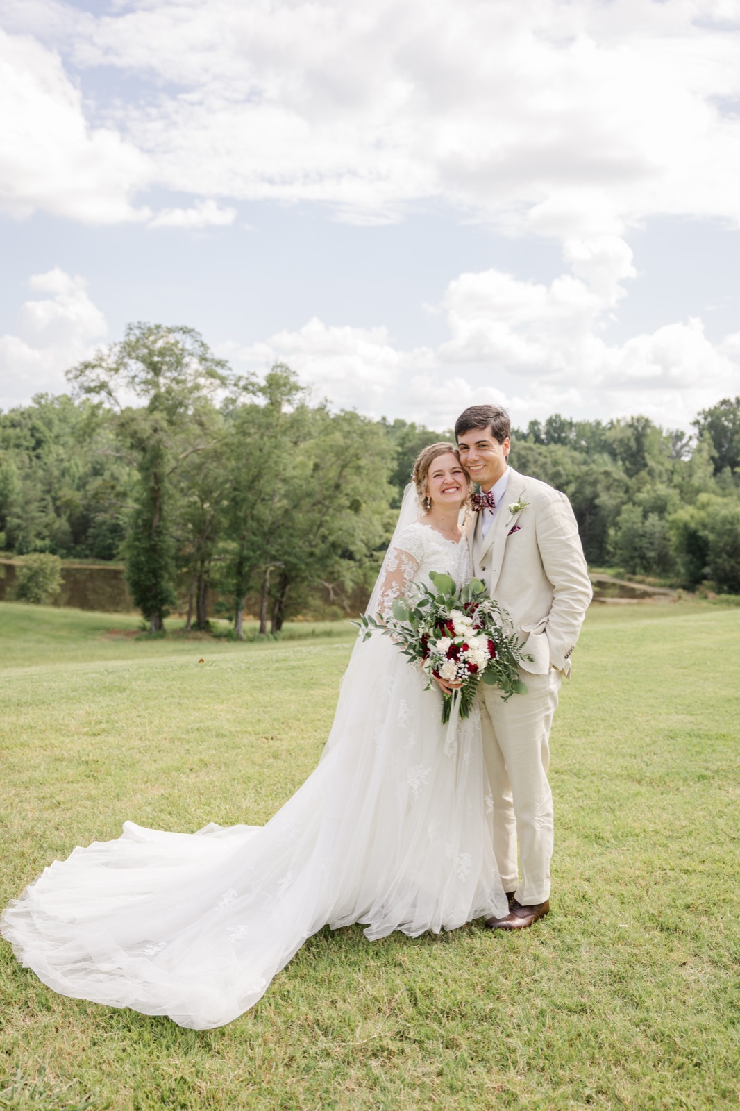 Bride and groom in custom lace wedding gown
